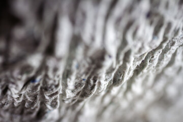 Extreme close up of old gray handmade paper mache with a structure and rough texture.