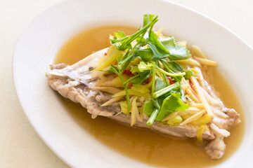 A delicious and healthy dish of steamed fish with ginger and scallions.
