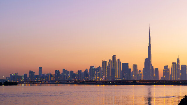 amazing sunset view of Dubai Downtown cityline from Dubai Creek, skyscrapers reflecting warm light, urban skyline at golden hour, modern cityscape, travel, lifestyle, architecture scene