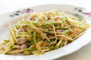 Spicy Thai mango salad with fresh mango. (Songkhla Mini Mango or Ma-Muang Baw)