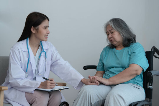 Woman doctor holding hand, take care and encourage elderly patien, which she is saddened from depression, to elderly and health care concept.
