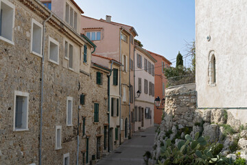 Fototapeta premium Street with medieval stone vintage houses in historic old town of Antibes, France.
