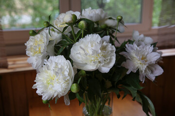 Blurred floral background. A bouquet of white peonies.