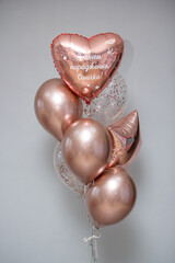 a bunch of rose gold balloons for a girl, the inscription on the balloon: “Happy birthday, Sonechka!”