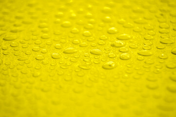 Water droplets on yellow cover background. Water droplets concept.