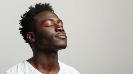 Obraz premium Black man with a calm demeanor isolated on a white background