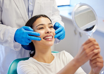 Woman, dentist and happy with mirror for dental surgery in clinic for teeth whitening and treatment...
