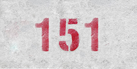 Red Number 151 on the white wall. Spray paint.