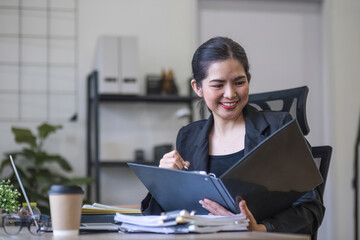 Portrait Of Attractive Asian Businesswoman Working On Laptop for marketing plan