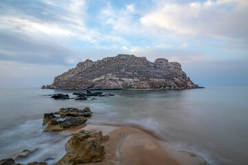 Panoramic view of Amarilla beach with Fraile Island in the background in Aguilas, Region of Murcia, Spain with soft sunrise light in an atmosphere of tranquility and peace