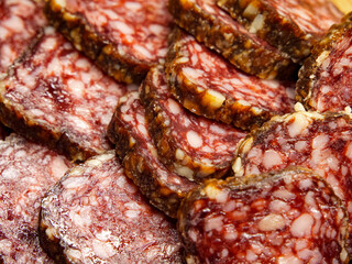Cured Meat Detail. Detailed salami texture showing marbled fat, suitable for cookbooks and food marketing.