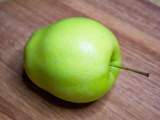 The apple’s freshness is evident, making it appealing for grocery store promotions.