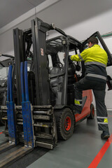 Forklift operator getting on his forklift
