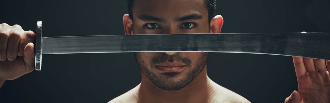 Samurai, sword and eyes in studio for battle, fight and martial arts or karate for dojo. Banner, Japanese man and blade for wellness, challenge and performance by black background with pride - Powered by Adobe