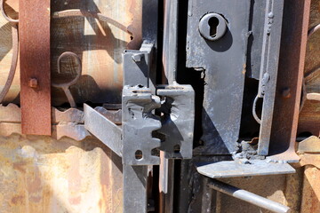 An old metal lock hangs on the fence.