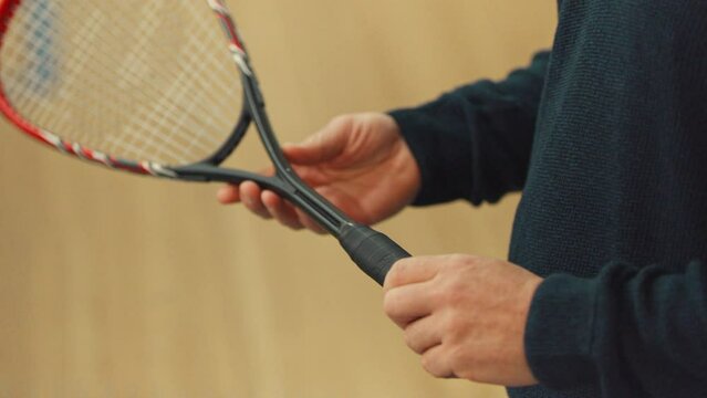 Squash Racquet and a player holding it