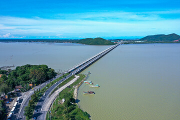 Aerial drone shot of the Tinsulanonda Bridge spanning across a lake in Songkhla Province, Thailand
