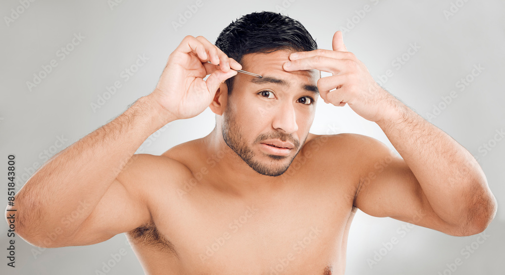 Poster Man, tweezers and eyebrow in studio portrait, grooming and plucking for epilation on white background. Male person, skincare and maintenance for hygiene routine or clean, beauty and facial cosmetics