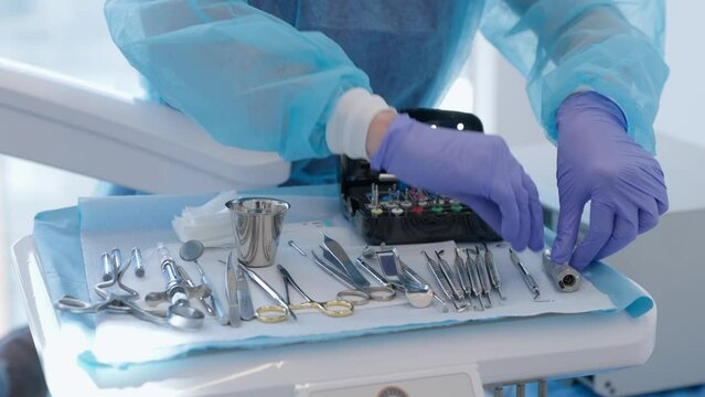 A dental assistant lays out medical instruments on the table. dental clinic and medical details. High quality 4k footage