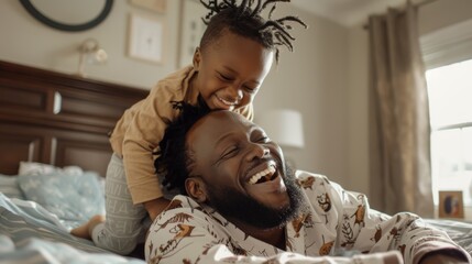 Children, love, and bedroom with a playful black family having fun in the morning. Kids, smile or laughing with a father and happy son playing or joking on a bed in their home