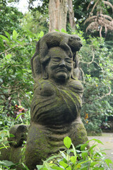 Fototapeta premium Stone statue with an monkey on a human head