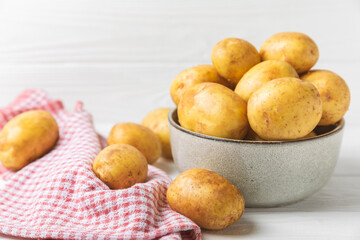 Young potatoes. Fresh potatoes  on a wooden background.Harvesting collection. organic, freshly dug potatoes. Agricultural background. Vegan. Vegetables.Place for text.Copy space