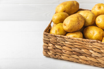 Young potatoes. Fresh potatoes  on a wooden background.Harvesting collection. organic, freshly dug potatoes. Agricultural background. Vegan. Vegetables.Place for text.Copy space