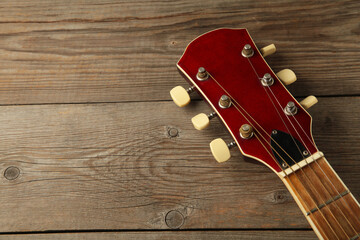 Guitar headstock on grey wooden background