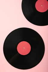 Gramophone vinyl records on pink background. Vertical photo