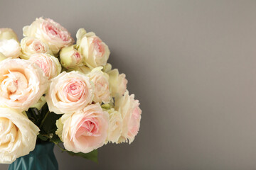 Bouquet of soft white roses on pink background. Floral still life with roses.