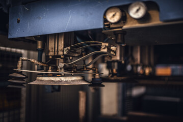 Pipes of industrial suction lifting equipment inside a factory.