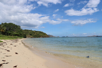 Beach with cumulus skies near Labuan Bajo