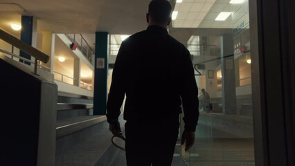 A Squash Player walking toward the court