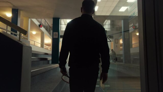 A Squash Player walking toward the court