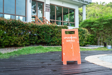 An upgrading service standing board which is placed in front of the building that under renovating....