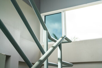 Obraz premium Close-up at stairway iron handrail banister of the high rise building place. Building equipment object part, selective focus.