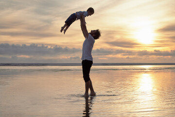 Dad, boy and happy at beach with lifting up for summer holiday, break and bonding in Australia. Parent, father and kid in ocean for child development or growth on vacation, adventure or trip together