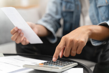 Household financial economic concept, Stressed Young Asian adults are looking at credit card bills...