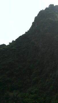 panoramic of the sharp mountains full of trees and vegetation near the cement factory and quarries in hanoi vietnam