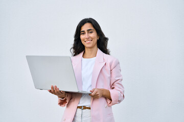 Smiling young middle eastern Israel businesswoman using laptop pc online application for work...