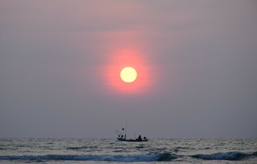 sailboat  at sunset in the sea.fisherman on the long tail boat go back home at sunset