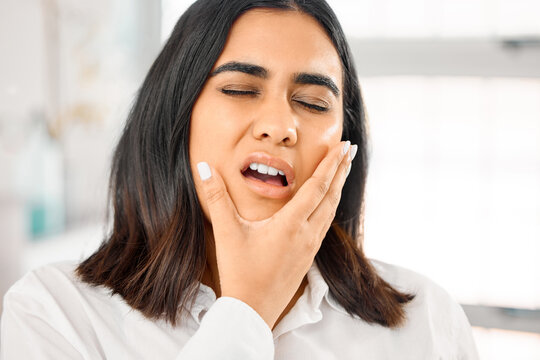 Woman, toothache and mouth pain in home for cavity, tooth infection or dental emergency. Gums, healthcare and female person with hand on face for oral hygiene, inflammation or gingivitis problem