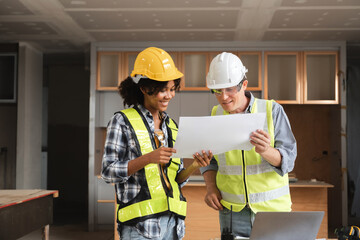 Engineering Team Discussing Construction Plans in Modern Building Site with Blueprints and Safety Gear