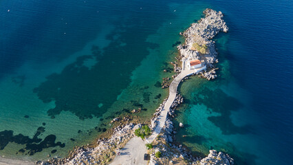 Little church of Agios Isidoros in the sea over the rocks, Chios island, Greece.