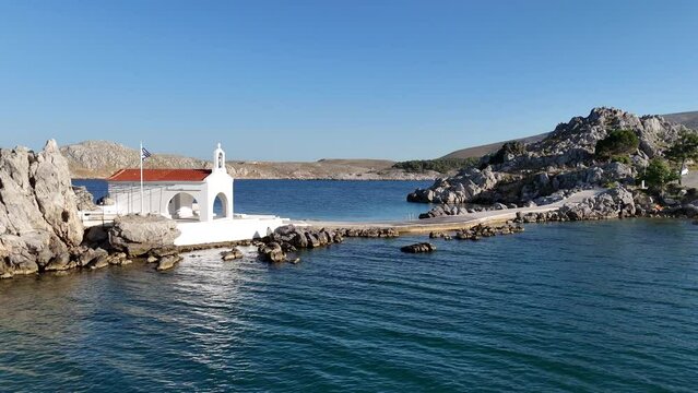Little church of Agios Isidoros in the sea over the rocks, Chios island, Greece.