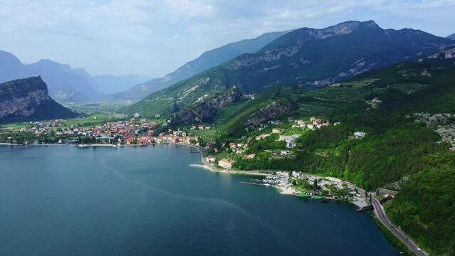 Torbole Lake Garda Aerial View with Mountains, Scenic Blue Water and Italian Town, Idyllic Summer Vacation Destination, Clear Sky and Coastal Road Background