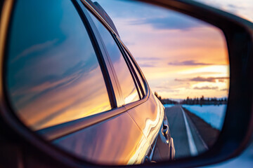 Reflection of Sunset Through Car Sideview Mirror