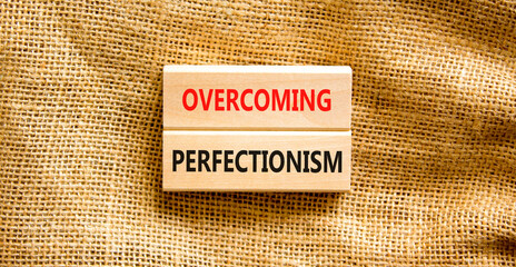 Overcoming perfectionism symbol. Concept words Overcoming perfectionism on beautiful wooden block....