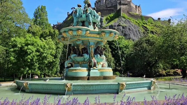 Ross Fountain and Edinburgh Castle from Princes Street Gardens, Scotland. Upward, panning motion.