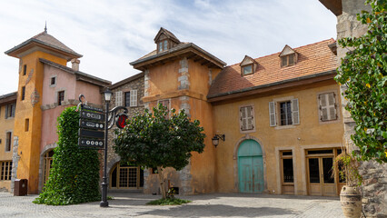 Walking area with shops and restaurants in United Arab Emirates. Riverland, Dubai. Houses in style of medieval Europe